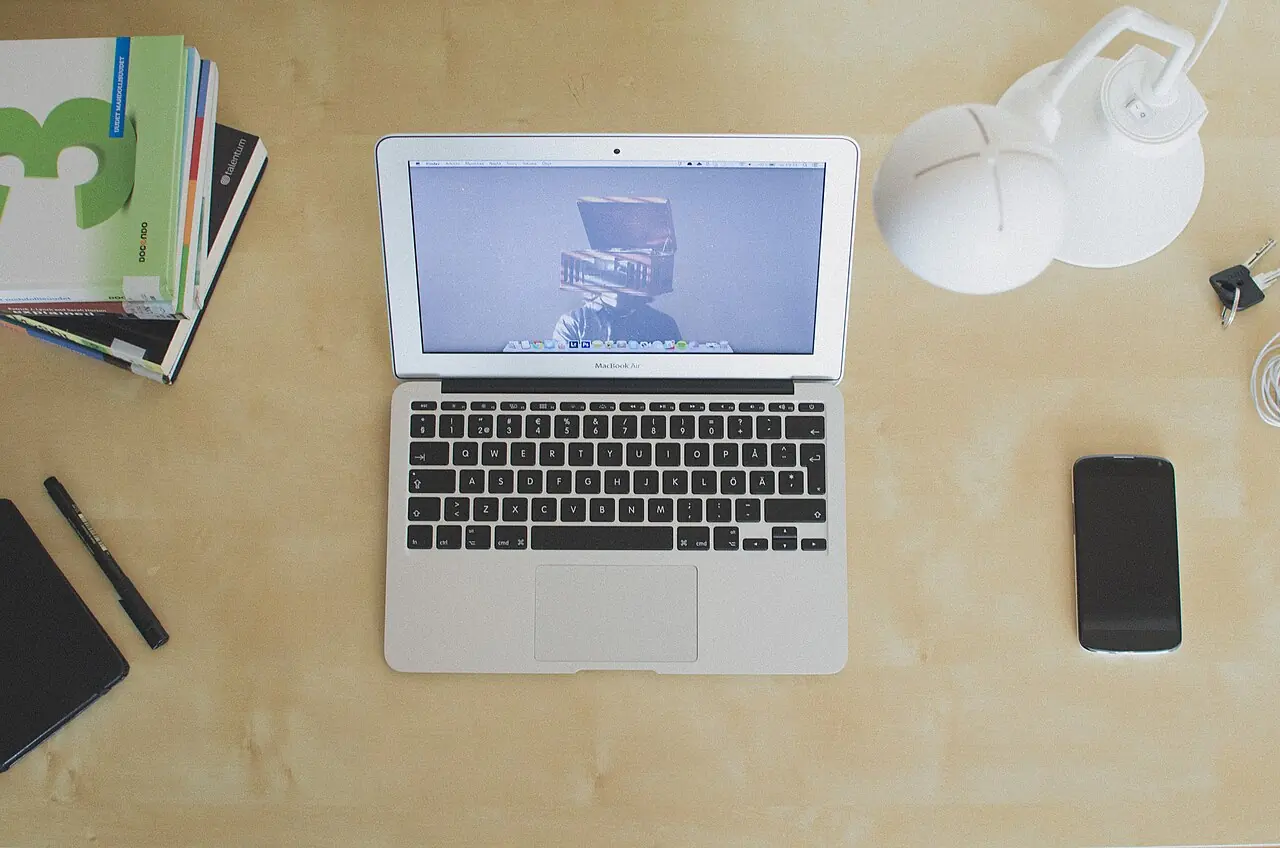 Laptop, phone and notebooks on a desk
