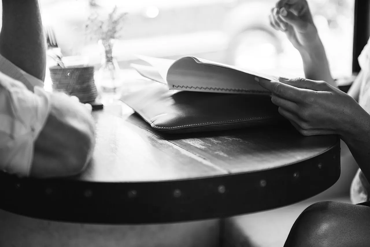 Two people reviewing a document in a café