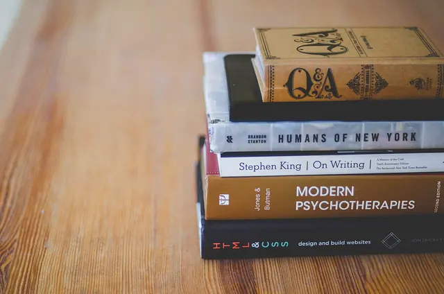Books stacked on a wooden table