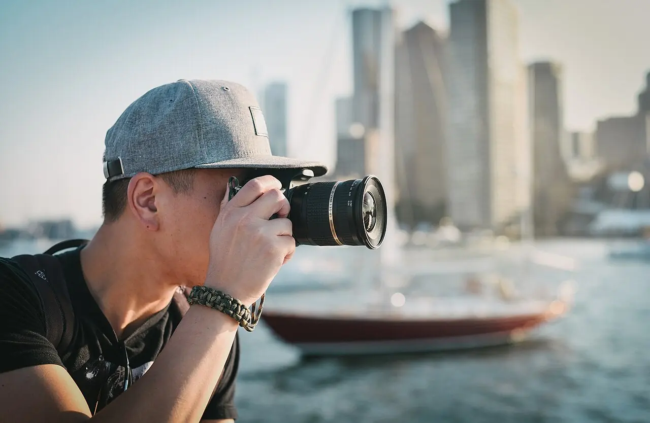 A person taking a photograph with a camera