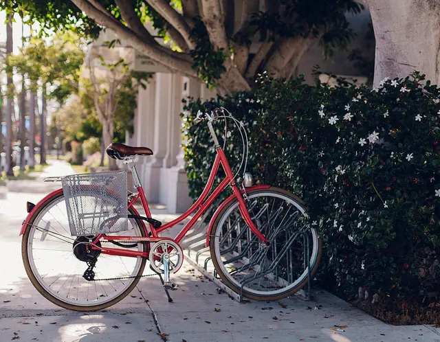 Red bicycle parked near a building